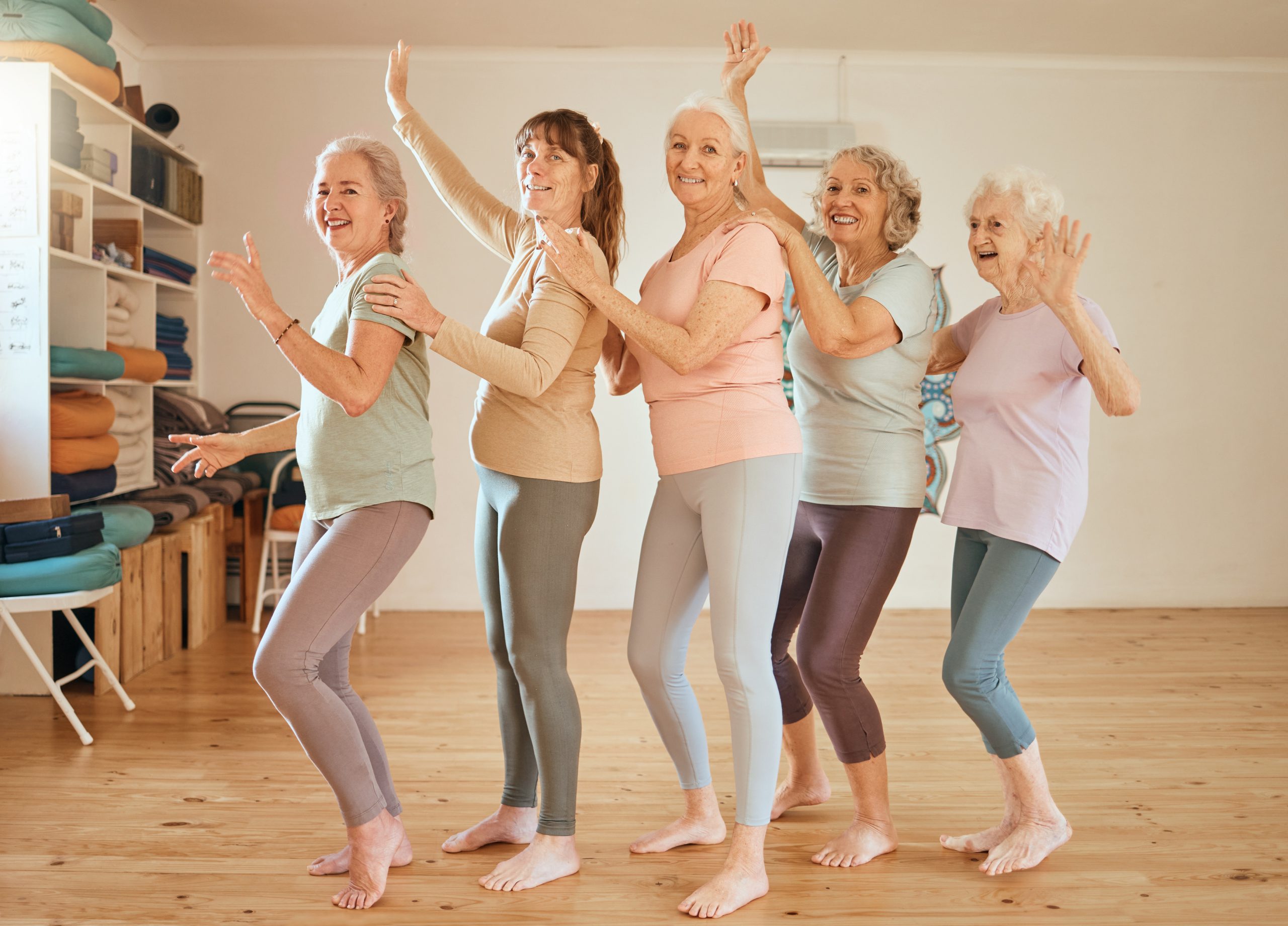 elderly yoga portrait friends row dance together class break cheerful fun retirement wellness senior friendship yoga class with happy healthy fitness women scaled